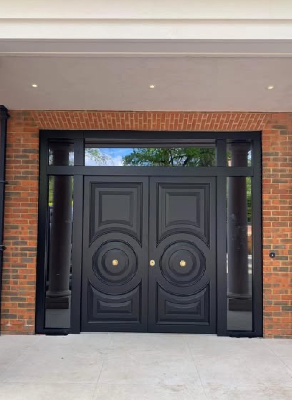 Black double entrance doors with sidelights and transom