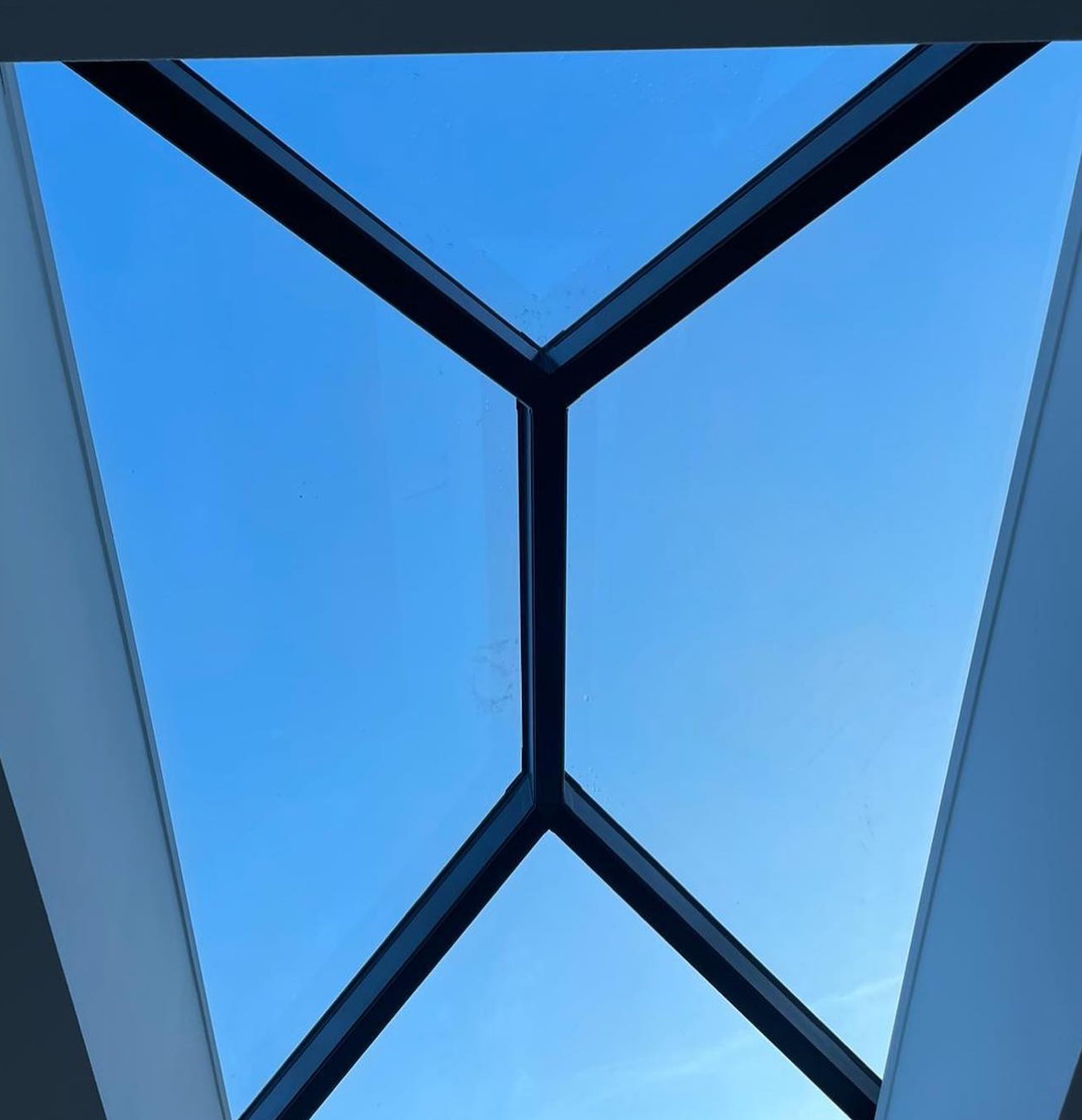 Aluminium roof lantern seen from inside against a blue sky